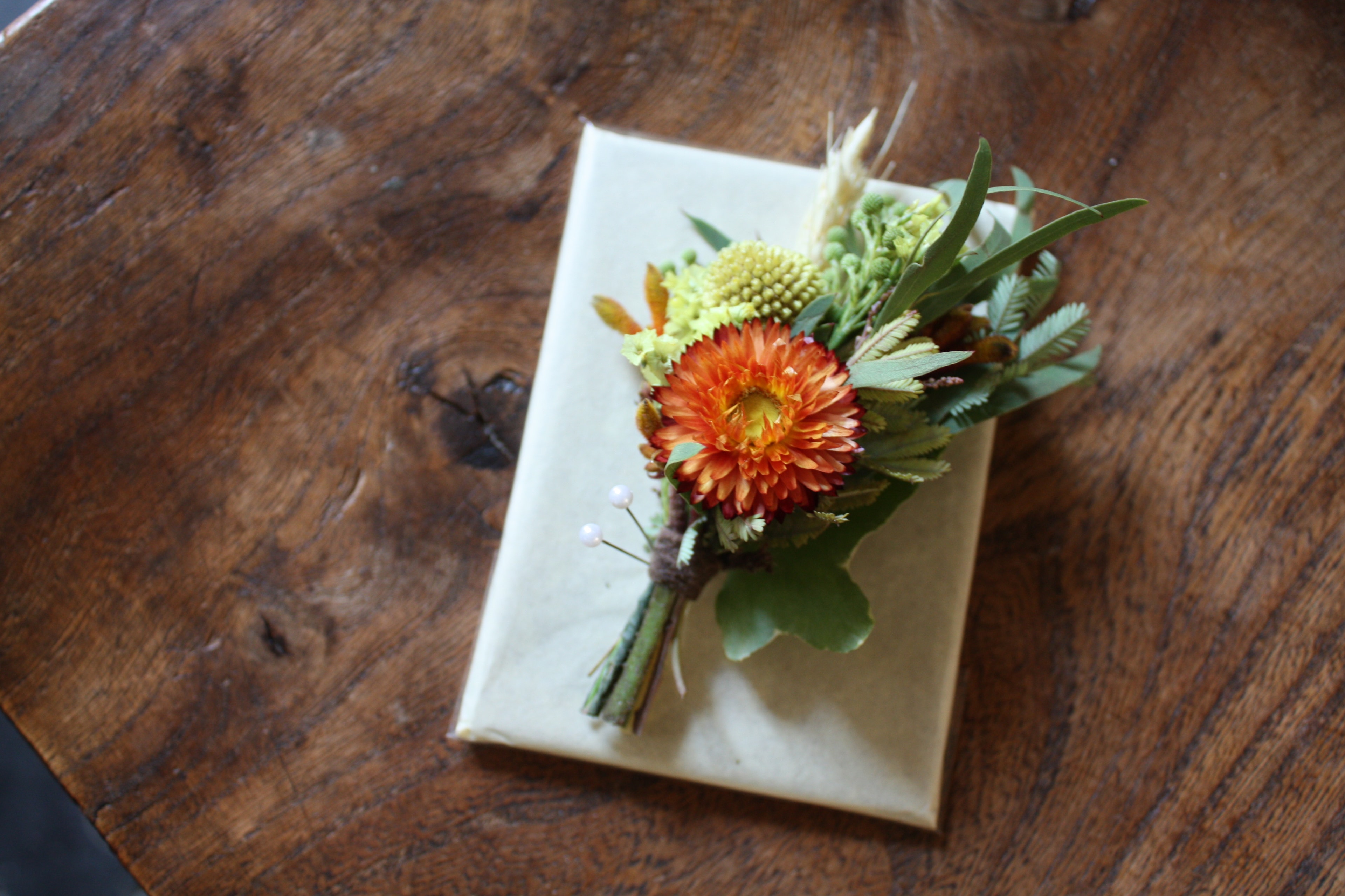 Mina's hands crafting a floral arrangement