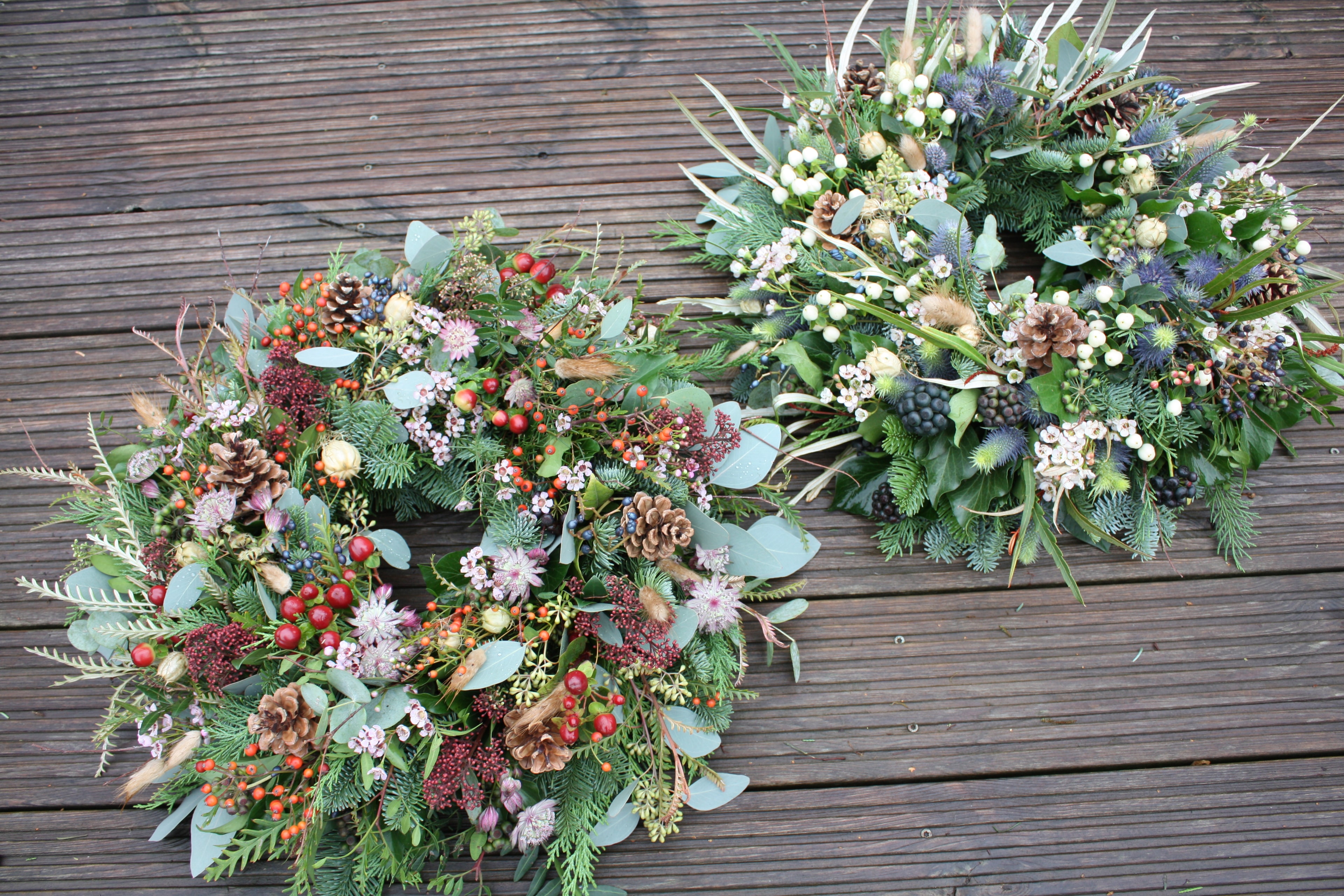 Seasonal wreaths with berries and pinecones